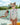 Little girl wearing AZULEJO - WINGS LONGSLEEVE swimsuit with pink floral design and sunglasses by the pool.